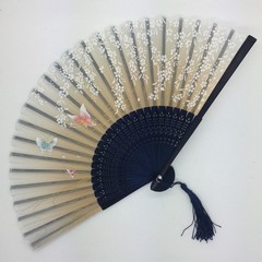 Hand fan made of wood with a pattern of blossom trees. Yellow